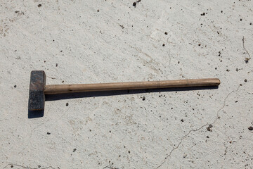 A hammer used on a concrete floor. Top view