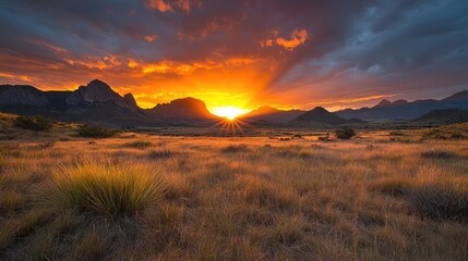 Obraz premium Dramatic sunset over desert mountains and plains. Use Travel/tourism promotion