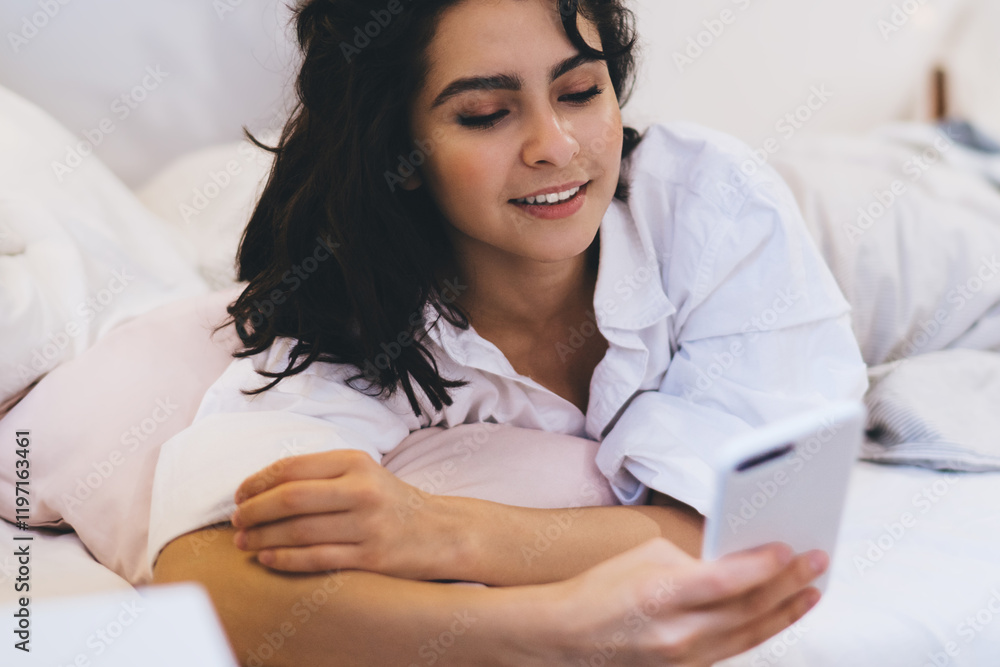 Aufkleber beautiful woman checking network news after awaking using smartphone gadget and home internet connec