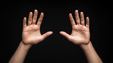 Hands raised in gesture against black background, conveying emotion and expression. image captures details of palms and fingers, emphasizing human form