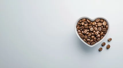  A bowl of coffee beans is placed in the shape of a heart © KayKai