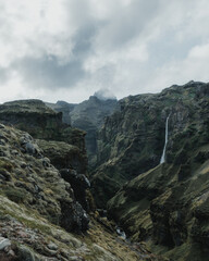 Breathtaking view of Mulagjufur Canyon in South Iceland with cliffs, waterfall, and lush green landscape