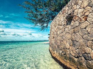 Grand Cayman, Cayman Islands - January 1, 2025: A rustic breakwall along the water of seven mile...