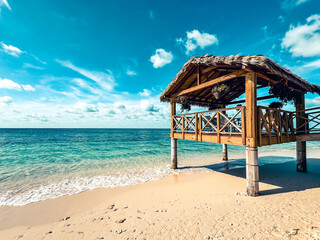 Grand Cayman, Cayman Islands - January 1, 2025: A gazebo hanging over the water of seven mile beach in Grand Cayman
