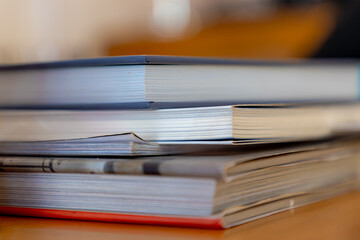 Reading concept, Selective focus of a pile of book and papers on the wooden table, Stacked of books on the desk, Hobby and leisure activities by learning, reading and study, Education background.
