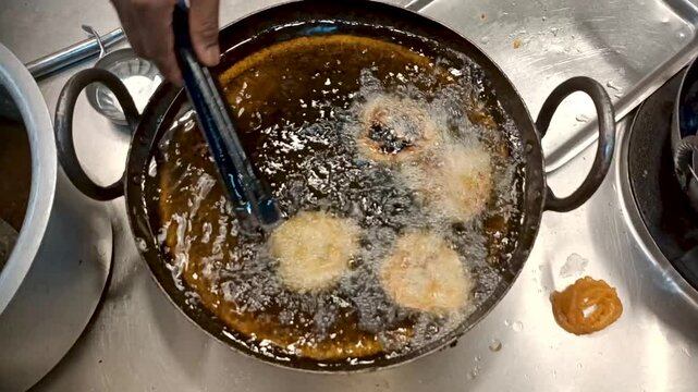 Mysuru,Karnataka,India-December 28 2024; A Cooking video of a popular Indian snacks Cutlet, samosa, kachori, being deep fried in a pan with mustard oil and garam masala ingredient.
