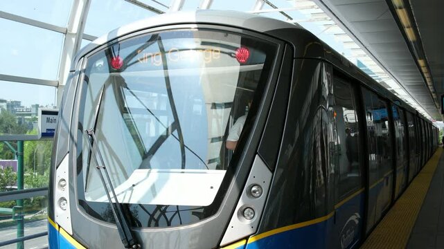 Vancouver Sky Train. The Skytrain elevated light rapid transit system crossing over a busy street, Vancouver, BC, Canada 