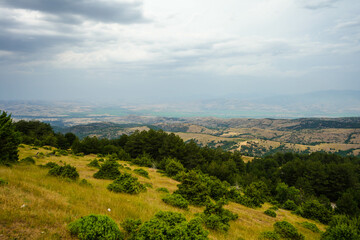 Obraz premium View from mountains across valley to south east with city of Stip on center horizon. Stip, Macedonia 