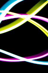 Neon Rainbow Light on Black Background Abstract Lines Swirls and Waves