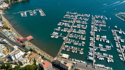 Aerial view of the marina located in Baia, a hamlet of Bacoli, in the metropolitan city of Naples, in Campania, Italy.