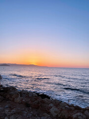 orange warm sunset over the blue calming sea nature background photo
