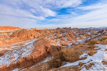 Colorful Danxia landscape in Zhangye Gansu blanketed by first snow creates stunning winter view