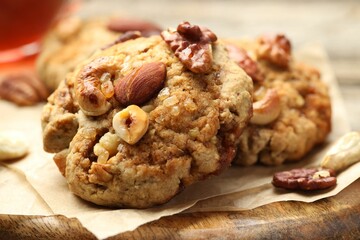 Tasty cookies with nuts on wooden table, closeup