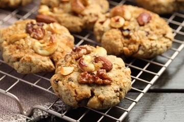 Tasty cookies with nuts on wooden table, closeup