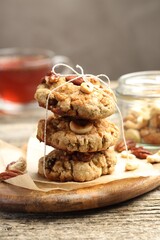 Tasty cookies with nuts on wooden table, closeup