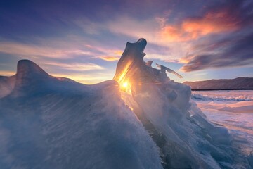 Winter landscape in a demon world showcasing surreal ice formations and vibrant sunset colors...