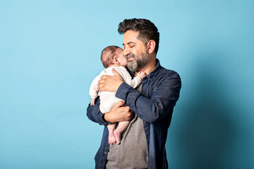 Loving Latino Father Holding and Embracing His Baby
