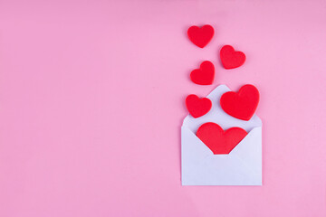 Valentine day background with lettering Happy Valentine Day, heart and envelop, on bright colored background, top view copy space, Valentines greeting card, invitation or menu background