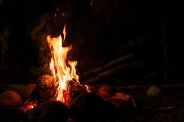 Burning firewood in the dark.