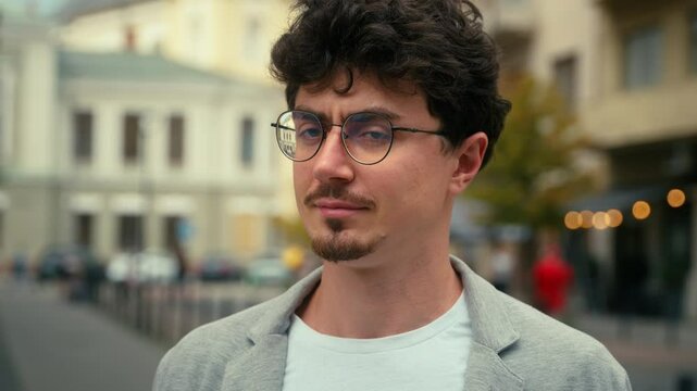 Portrait headshot serious pensive thinking contemplate calm male Hispanic man guy think ponder outside in city street outdoor looking at camera outdoors face look business businessman solution decide