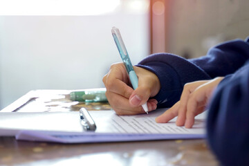 Thai students take a knowledge test to assess knowledge skills. The result of the exam will come out as a score value. Allows us to analyze the results or grade. Soft and selective focus.