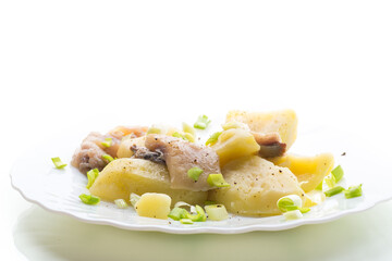Homemade potatoes with aromatic fish, isolated on white background