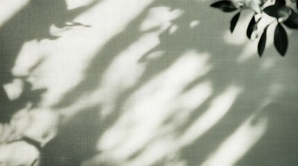 Natural Linen Texture with Soft Shadows and Green Leaves Creating a Serene Backdrop for Text Placement in Light Gray Tones