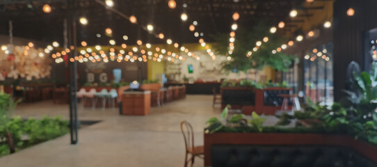 Blurry background of restaurant with light bulb and rustic style