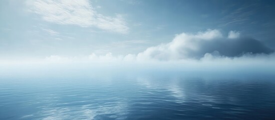 Fototapeta premium Calm ocean surface with soft clouds reflecting in water under a clear blue sky Copy Space