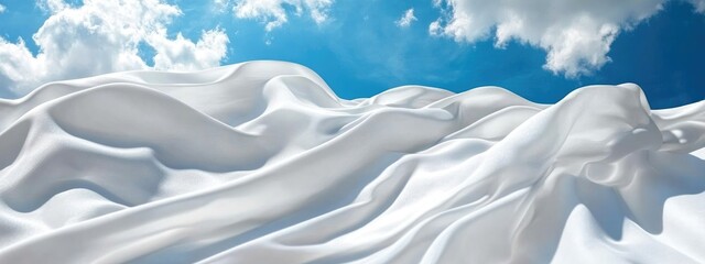 Obraz premium Snowy landscape with soft undulating snow drifts under a bright blue sky and fluffy clouds Copy Space