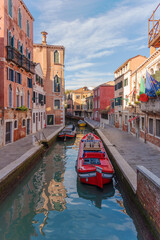 Venetian Canal Scene with Red Motorboat and Colorful Buildings