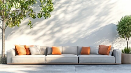 Modern outdoor sofa with orange cushions beside potted plants against a neutral wall with natural shadows Copy Space