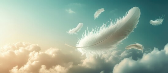 Soft white feathers drifting through a serene blue sky with clouds and copy space for text placement.