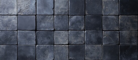 Naklejka premium Dark textured stone tiles arranged in a grid pattern with Copy Space for text placement