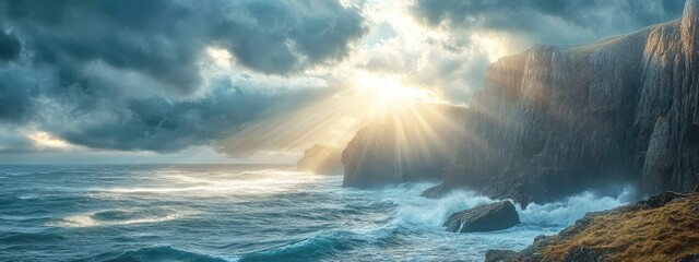 Fototapeta premium Dramatic coastal landscape with sunlight breaking through clouds over ocean waves and rocky cliffs during sunset Copy Space