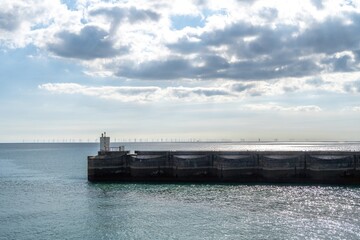 The West Wall at Brighton Marina with wind turbines in the background