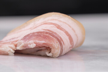 Homemade lard piece on marble light board on white table