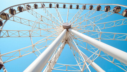 Obraz premium Giant Ferris wheel towering above amusement park, joyful excitement