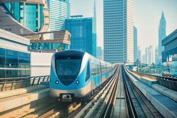 Naklejka premium Dubai metro train fully automated and driverless train system, seamlessly integrated into futuristic skyline, passing through modern skyscrapers and modern architecture in Dubai city
