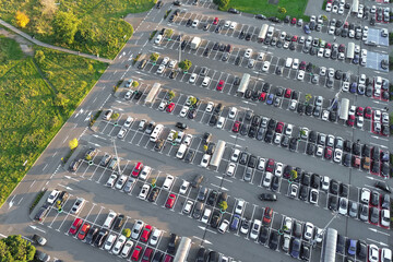 Aerial view of large parking lot with many cars.