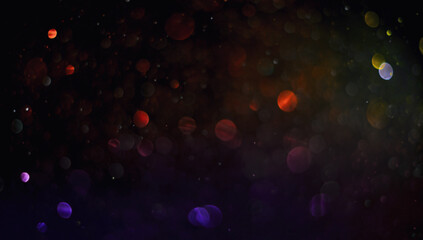 Holiday abstract bokeh on black background. Festive sparkling gold dust. Holiday concept