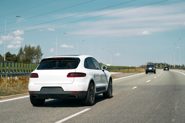 Car speeding down a clear highway road.