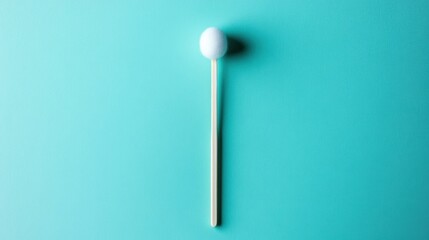 Simple White Ball on Stick Against Bright Blue Background