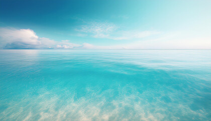 Obraz premium A serene and tranquil seascape of a calm ocean meeting a clear blue sky. The water is a crystal-clear turquoise color, and the surface is gently rippled by a soft breeze.