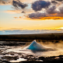 Strokkur geysir dome moments before eruption at sunset in south Iceland...