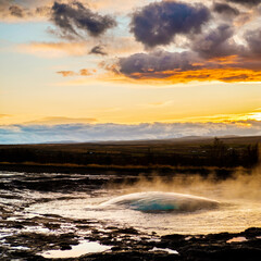 Strokkur geysir dome moments before eruption at sunset in south Iceland..