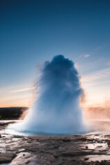 Strokkur Geysir eruption at sunset in south Iceland, Haukadalur valley