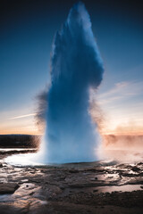 Strokkur Geysir eruption at sunset in south Iceland, Haukadalur valley