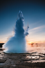 Strokkur Geysir eruption at sunset in south Iceland, Haukadalur valley