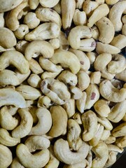Full frame top view of huge amount of raw tasty cashews